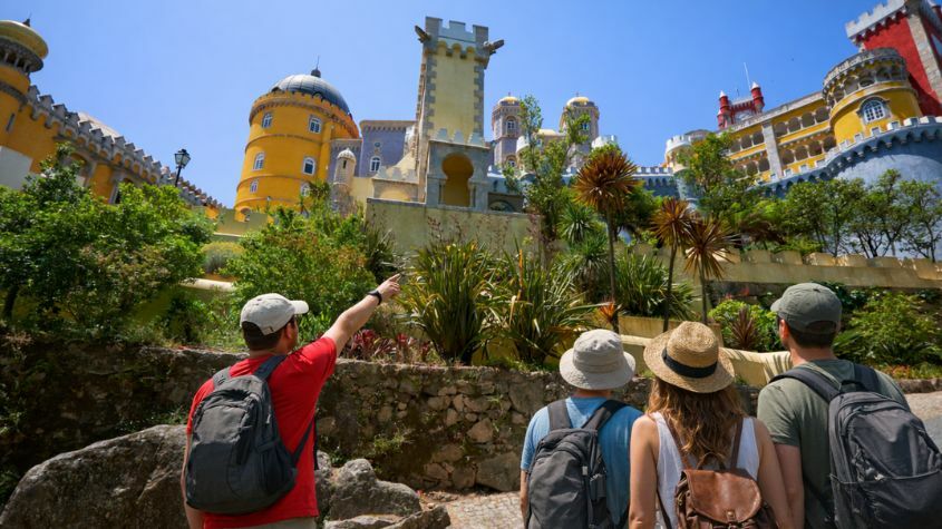 Family of tourists admiring the Pena Palace in Sintra with a Living Tours guide
